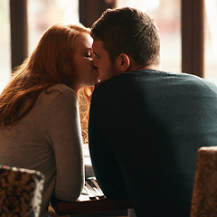 Image showing Couple, love and kiss on date at cafe for bonding, romance or healthy relationship with rear view. Man, woman and affection at restaurant with caring, trust and fine dining on anniversary vacation