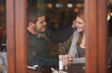 Image showing Couple, smile and holding hands on date at restaurant for bonding, romance and healthy relationship with relax. Man, woman and affection at cafe with happiness, trust and love on anniversary vacation