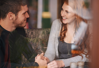 Image showing Couple, smile and holding hands on date at cafe for bonding, romance and healthy relationship with relax. Man, woman and affection at coffee shop with happiness, trust or love on anniversary vacation