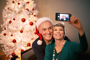 Image showing Christmas, selfie and senior couple with love, holiday and support in home with social media. Happy, retirement and marriage with smile and profile picture in house with celebration and santa hat