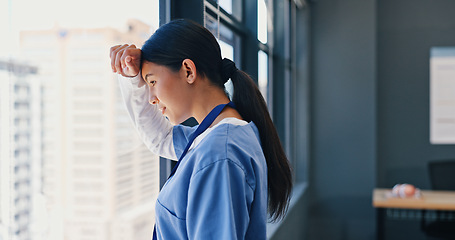 Image showing Nurse, healthcare and thinking at window of hospital with depression, medical decision and burnout. Medicine, woman and thoughtful professional doctor in clinic with mental health, stress and anxiety