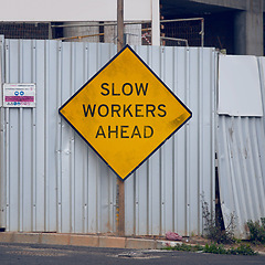 Image showing Road sign, warning and signage in street for construction with caution notification and yellow triangle outdoor. Attention, public notice and signpost for roadworks, alert message and symbol in city