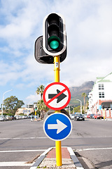 Image showing Road sign, traffic light and signage in street for direction with attention notification and arrow symbol outdoor in city. Board, public notice and signpost for route, alert message and advertisement