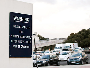 Image showing Parking lot, warning and sign on wall with error for caution, notification and information. Public signage, symbol and humor or mistake on board, poster and message for attention, security and safety