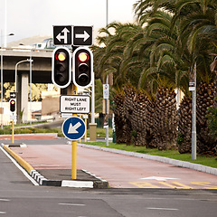 Image showing Street, traffic light and sign with arrow in city with mistake for humor, joke and comic grammar for direction. Asphalt, error and funny signage with board, poster or design for warning on metro road