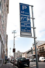 Image showing Road sign, warning and signage in street for parking with caution notification and blue square outdoor in city. Attention, public notice and signpost for car park to pay, alert message and symbol