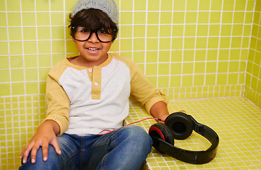 Image showing Child, portrait and glasses with cool headphones in bathroom with music in a home. Radio, eyewear and youth fashion with a hipster boy listening to audio with with style in a house with frames