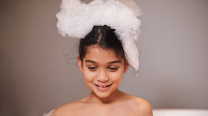 Image showing Bubble bath, smile or happy girl with soap in a house for body care, washing or cleaning. Bathtub, face and playful kid in bathroom with wellness skincare cosmetics, hygiene or fun with water splash