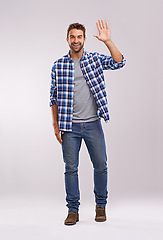 Image showing Man, portrait and wave hello in studio for happy greeting on white background or communication, friendly or mockup space. Male person, face and hand gesture for welcome sign, recognition or farewell