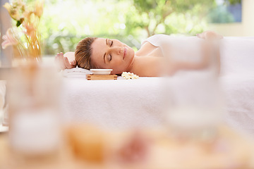 Image showing Woman, relax and sleeping with towel at spa in stress relief, zen or health and wellness on massage table. Calm female person enjoying luxury skincare, body treatment or relaxation at peaceful resort