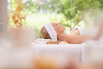 Image showing Lady, spa and rest for zen, peace and wellness with relaxation and calm. Woman, towel and massage table at resort, lounge or luxury parlor with rose for holistic body and skincare for detox and break