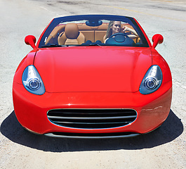 Image showing Convertible, sports car and drive in luxury on road in city, outdoor in summer or motor travel with woman. Vehicle, transport and female driver on highway, street or driving on holiday and vacation