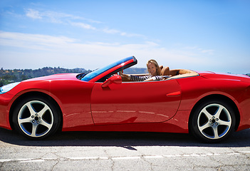 Image showing Woman, red sports car and road trip for holiday, travel and luxury transport on summer drive. Happy female person, convertible and countryside wellness on street, vacation and adventure in vehicle