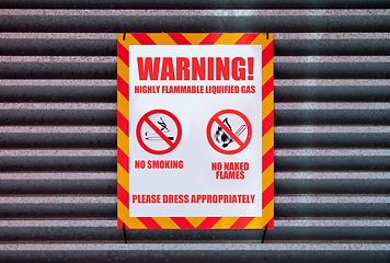 Image showing Poster, warning and signage on board for sign with caution notification or red square on garage by building. Attention, public message and signpost for no smoking, comic signal and symbol for humor
