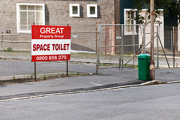 Image showing Poster, board and sign for property outdoor on fence in street for neighborhood notification and real estate marketing. Attention, public notice and signpost with advertisement and residential sale