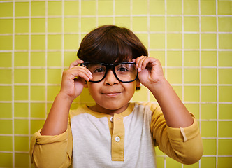 Image showing Child, portrait and glasses with smile and bathroom with vision in a home. Happy, eyewear and youth fashion with an Indian boy with modern and casual style in a house with confidence and frames