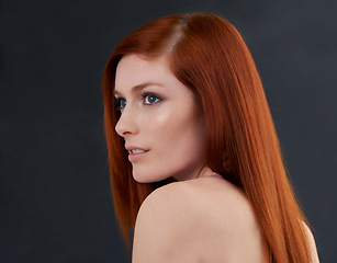 Image showing Hair care, red and woman with shine, wellness and treatment with beauty on a dark studio background. Luxury, person and model with shampoo and grooming routine with growth or cosmetics with beauty