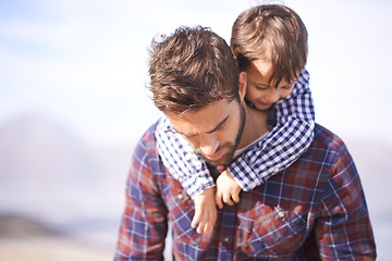 Image showing Beach, piggy back and man with child on shoulders, smile and relax on outdoor adventure. Support, father and son in nature for fun, bonding and happy trust on ocean holiday together with travel