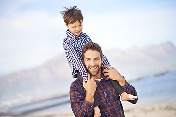 Image showing Ocean, portrait and man with child on shoulders, walking and smile on outdoor bonding adventure. Nature, father and son at beach for travel, trust and holiday together with support, love and growth.