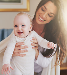 Image showing Family, home and mother playing with baby for bonding, relationship and care for motherhood. Love, parenting and happy mom with newborn infant for child development, support and affection in house