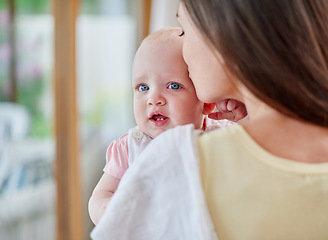 Image showing Family, kiss and mother with baby in home for bonding, relationship and love for motherhood. Happy, parents and mom carrying newborn infant for child development, support and affection in house