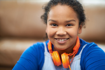 Image showing Children, portrait or girl with headphones in a house with music, relax and chilling on weekend. Happy, face and kid in living room streaming album, playlist or audio storytelling for remote learning