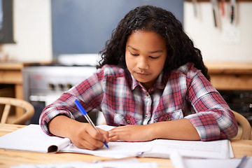 Image showing Child, studying and writing in classroom for education assignment for lesson, knowledge or literature. Female person, notebook and desk for english project at school academy, learning or creativity