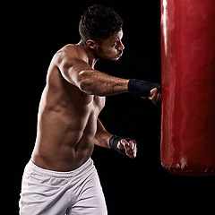Image showing Boxing, man and training in studio with punching bag for workout, exercise or competition fight with fitness. Athlete, boxer and confidence for martial arts with power and topless on black background