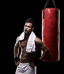 Image showing Tired, boxer and man with towel in studio with gloves for training with strength and muscle. Adult, athlete and male person in dark background, healthy and power with body, punching bag and sport