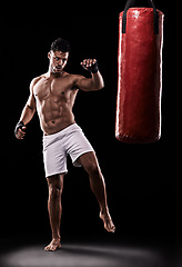 Image showing Kickboxing, man and workout in studio with punching bag for training, exercise or competition fight with fitness. Athlete, boxer and strong for martial arts with power and topless on black background