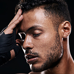 Image showing Hands, gloves and tired man boxer in studio with headache, stress or intense exercise burnout on black background. Sweat, face and male athlete with sports, fatigue or pause for workout recovery