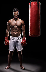 Image showing Serious, boxer and portrait of man in black background with gloves for training with strength and muscle. Adult, athlete and male person in studio, healthy and power with body, punching bag and sport