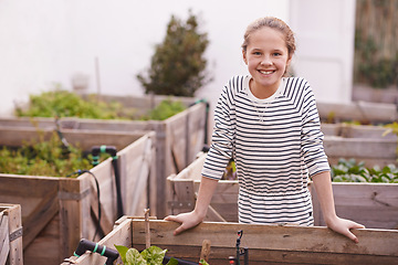 Image showing Child, smile and portrait in backyard or garden for plants or gardening in environment for sustainable. Little girl or kid and happy with joy for leaf and grow for childhood and young in outdoor