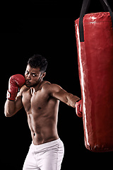 Image showing Man, box and punching bag for active, exercise and health for wellness and sports with muscles in studio. African person and punch for strong, fitness and power for recreation and workout for fight