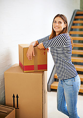 Image showing Smile, boxes and portrait of woman in new home for moving to estate, property or apartment. Happy, excited and young female person with cardboard package for equipment and products in modern house.