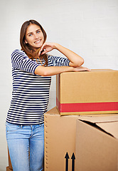 Image showing Moving, boxes and portrait of woman in new home, estate or apartment for property. Happy, smile and confident young female person with cardboard package for equipment and products in modern house.