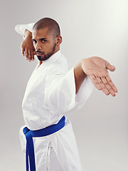 Image showing Studio, karate and black man with technique for martial arts with hand strike, shuto uchi and training. White background, adult and African male person with healthy body for movement and disciple