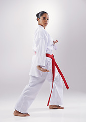 Image showing Woman, portrait and karate fitness in studio, warrior and martial arts on white background. Black person, athlete and red belt for taekwondo, discipline and warrior ready for self defense or battle