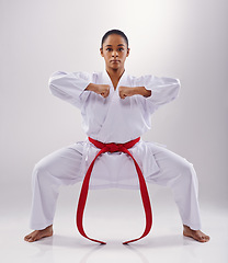 Image showing Woman, portrait and karate fighter in studio, fitness and martial arts on white background. Black person, athlete and red belt for taekwondo, discipline and warrior ready for self defense or battle