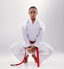 Image showing Karate, exercise and portrait of woman in studio, white background and stretching in mockup space. Mma, student or person in martial arts with serious attitude of warrior for workout and training
