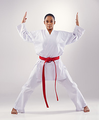 Image showing Woman, portrait and hands for karate in studio, fitness and martial arts on white background. Black person, athlete and red belt for taekwondo, discipline and warrior ready for self defense or battle