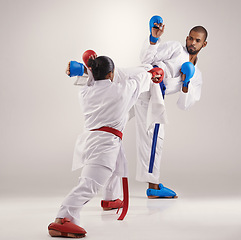 Image showing People, karate and kick to practice in studio on white background with focus to fight or train for competition. Mma, sport and glove for fitness with technique, commitment and confidence as fighter