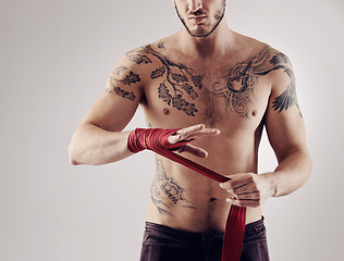 Image showing Wraps, MMA and male fighter for martial arts, boxing and angry on white background. Fist, athlete and exercise for man kickboxer, studio and training for impact sports competition and fitness