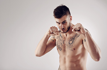 Image showing Fitness, MMA and portrait of male fighter for martial arts, boxing and angry on white background. Fist, athlete and exercise for man kickboxer, studio and training for impact sports competition