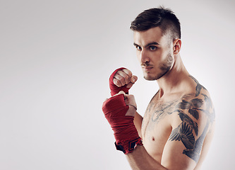 Image showing Fist, MMA and wraps for male fighter or boxer, pose and boxing on white background. Fitness, hands or athlete for exercise and man kickboxer, mockup space or training for impact sports or competition
