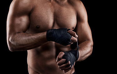 Image showing Boxing, person or hand wrap in studio with getting ready to fight, exercise or training on mockup space. Athlete, boxer or martial arts workout for competition, closeup or topless on black background