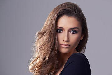 Image showing Hair, model and portrait in studio for salon, treatment and glow on isolated grey background. Shampoo, confident and face of female person with natural cosmetics, hairstyle and volume in mockup space