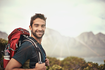 Image showing Man, hike and satisfied for adventure with backpack for fitness, workout and explore with hobby in Canada. Lens flare, portrait and smile in nature for healthy mind in woods and summer holiday