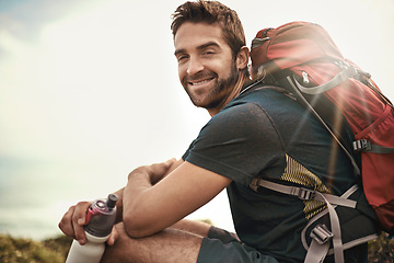 Image showing Man, hike and happiness for adventure with water bottle or backpack for fitness, workout and explore in Los Angeles. Portrait, smile and sit in outdoor or nature for health in woods on summer holiday