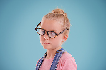 Image showing Child, portrait and eye glasses vision in studio for optometry healthcare for youth development, blue background or mockup space. Female person, kid and eyewear for spectacle frame, sight or lens